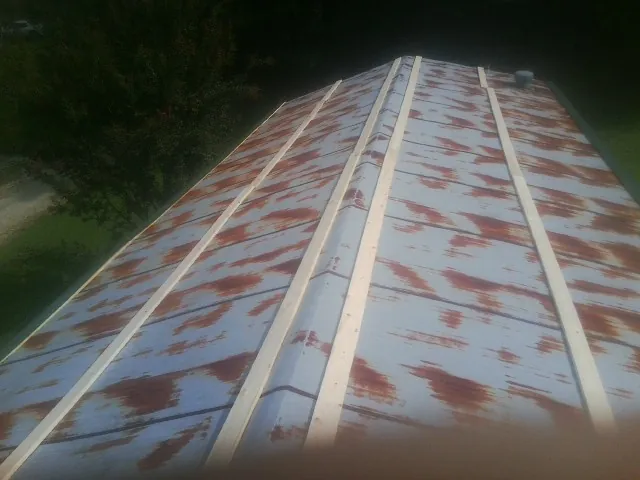 Rusted metal roof panels with new wood purlins before replacement — Storm Damage Roof Repair in Mentor by Roofing Brothers